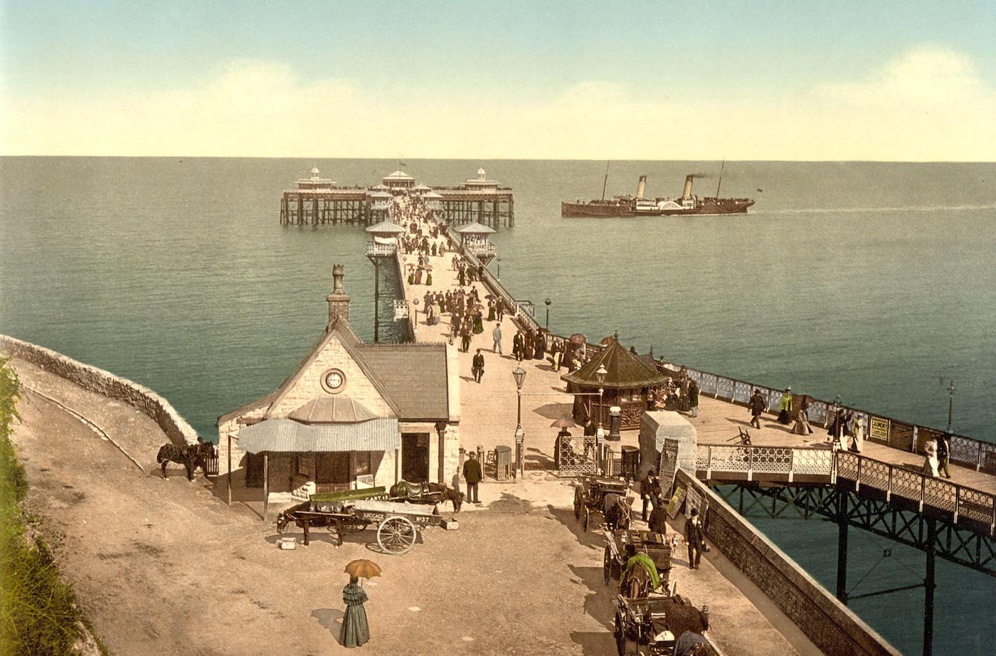 Vintage colour photo, c. 1890, of Llandudno Pier on the North Wales coast. It opened in 1877 and incorporated a landing stage for steam ships.